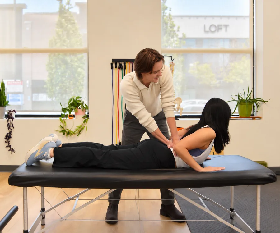 A clinician guiding a patient through a gentle lying back extension at the Form and Function Lincoln Park clinic