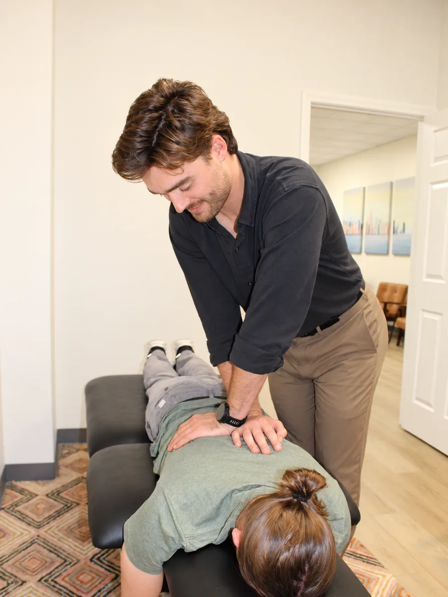 Clinician performing a hands-on spinal treatment on a patient at the Form and Function clinic